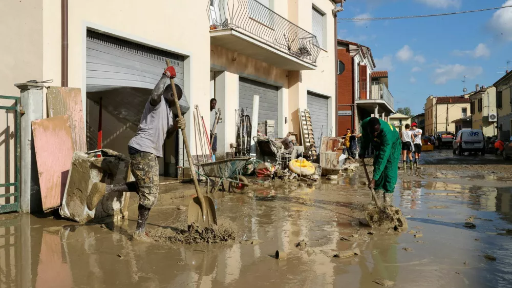 People clean up, following floods triggered by severe weather, in Traversara, Emilia-Romagna, Italy, September 20, 2024. REUTERS/Ciro de Luca