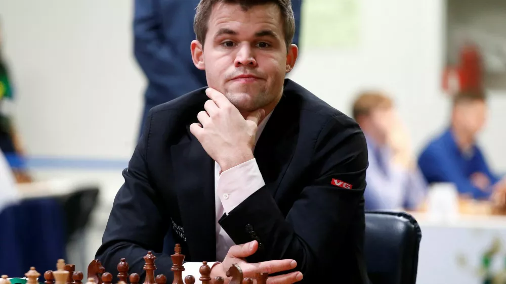 FILE PHOTO: Chess - 2018 World Rapid and Blitz Chess Championships - Rapid Open - Saint Petersburg, Russia - December 26, 2018. Magnus Carlsen of Norway plays against Adam Tukhaev of Ukraine. REUTERS/Anton Vaganov/File Photo