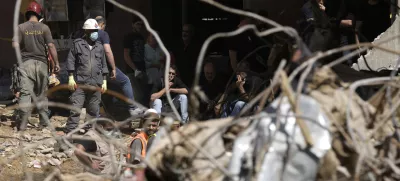 Emergency workers clear the rubble at the site of Friday's Israeli strike in Beirut's southern suburb, Sunday, Sept. 22, 2024. (AP Photo/Bilal Hussein)