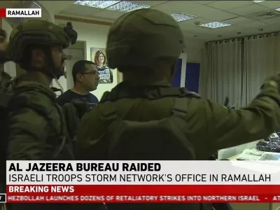 This image made from video provided by Al Jazeera English shows Israeli troops raiding their bureau in Ramallah, West Bank, Sunday, Sept. 22, 2024. (Al Jazeera via AP)