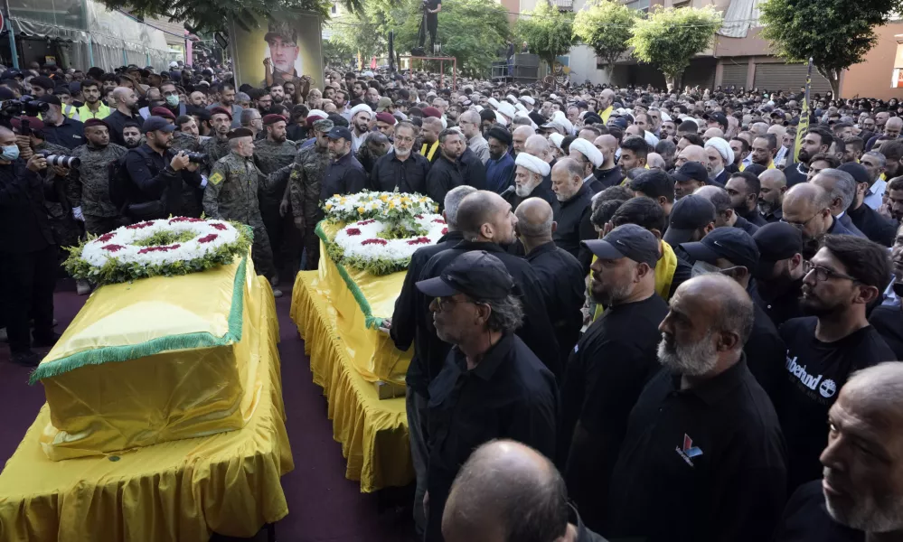 Hezbollah's deputy leader Naim Kassem, centre, speaks during the funeral of Hezbollah commander Ibrahim Akil and militant Mahmoud Hamad in Beirut's southern suburb, Sunday, Sept. 22, 2024. (AP Photo/Bilal Hussein)