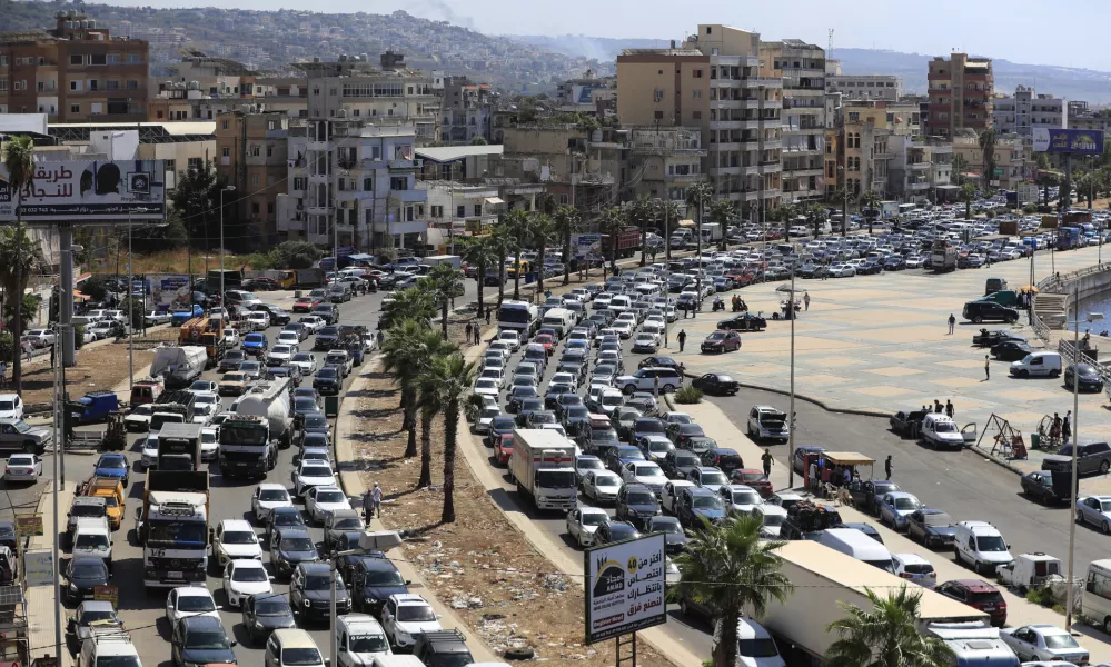 Cars sit in traffic as they flee the southern villages amid ongoing Israeli airstrikes, in Sidon, Lebanon, Monday, Sept. 23, 2024. (AP Photo/Mohammed Zaatari)