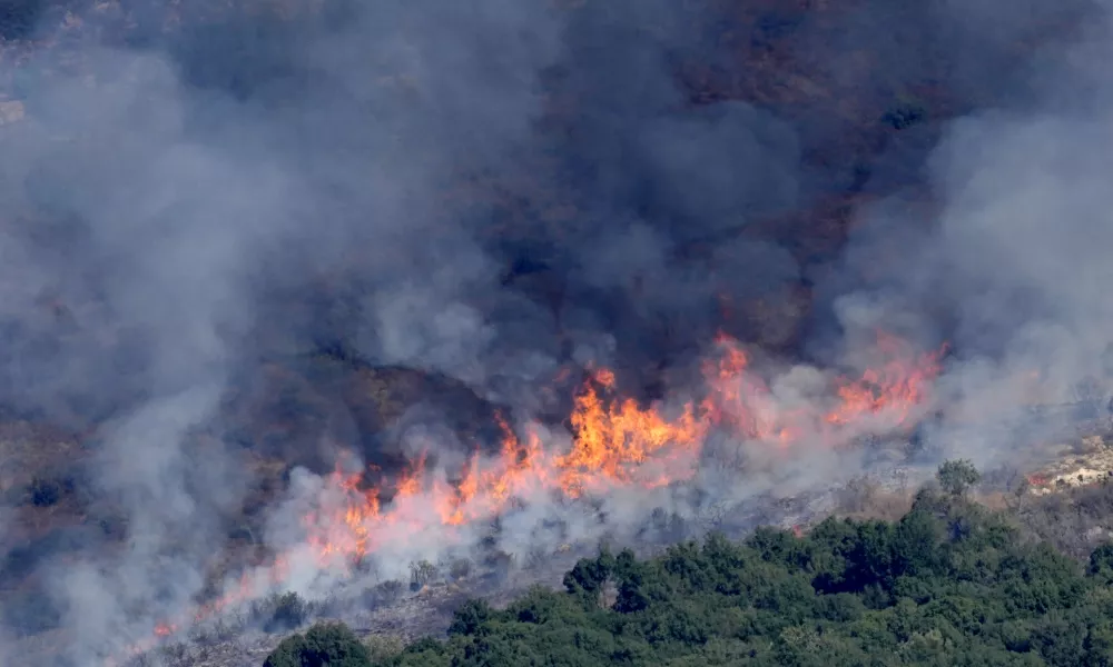 Flames and smoke rise from an Israeli airstrike on the Mahmoudieh mountain, as seen from Marjayoun town, south Lebanon, Tuesday, Sept. 24, 2024. (AP Photo/Hussein Malla)