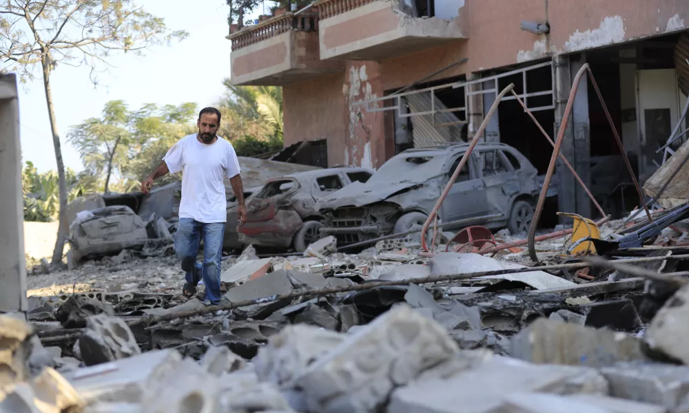 A man checks the damage to a building hit in an Israeli airstrike in the southern village of Akbieh, Lebanon, Tuesday, Sept. 24, 2024. (AP Photo/Mohammed Zaatari)