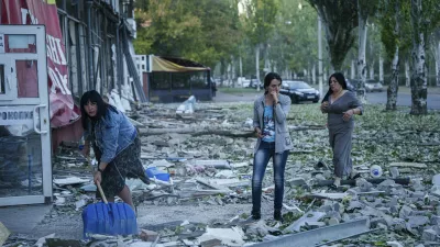 People clear the rubble in a front of a residential building heavily damaged after a Russian airstrike in Kramatorsk, Donetsk region, Ukraine, Wednesday, Sept. 25, 2024. (AP Photo/Evgeniy Maloletka)