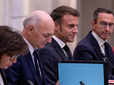 FILE PHOTO: French President Emmanuel Macron is flanked by new Justice Minister Didier Migaud and new Interior Minister Bruno Retailleau during the first weekly cabinet meeting at the Elysee Palace Monday, Sept. 23, 2024 in Paris, France.   Christophe Ena/Pool via REUTERS/File Photo