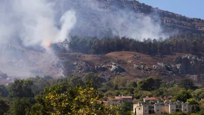 Smoke and flames are visible near homes in Kiryat Shmona after a rocket attack launched from Lebanon, amid cross-border hostilities between Hezbollah and Israel, in northern Israel, September 26, 2024. REUTERS/Jim Urquhart