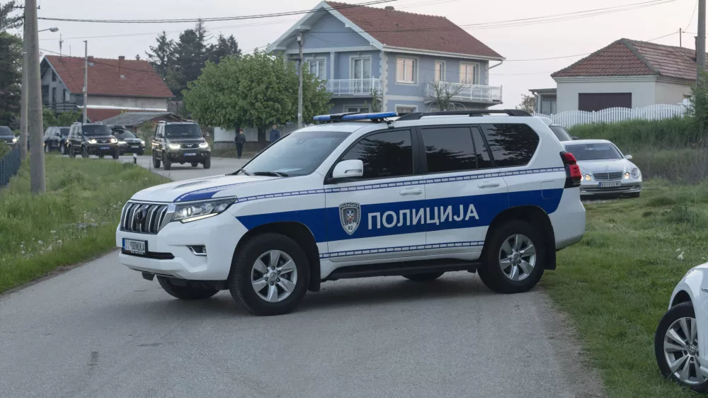 A police vehicle blocks the entrance to the village of Dubona, some 40 kilometers south of Belgrade, Serbia, Friday, May 5, 2023. A shooter killed multiple people and wounded more in a drive-by attack late Thursday in Serbia's second such mass killing in two days, state television reported. (AP Photo/Marko Drobnjakovic)