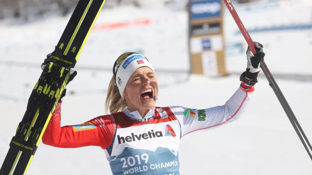 ﻿06 March 2021, Bavaria, Oberstdorf: Norway's Therese Johaug celebrates as she crosses the finish line to win the Women's Mass Start 30km Classic cross country race at the FIS Nordic Ski World Championships. Photo: Karl-Josef Hildenbrand/dpa