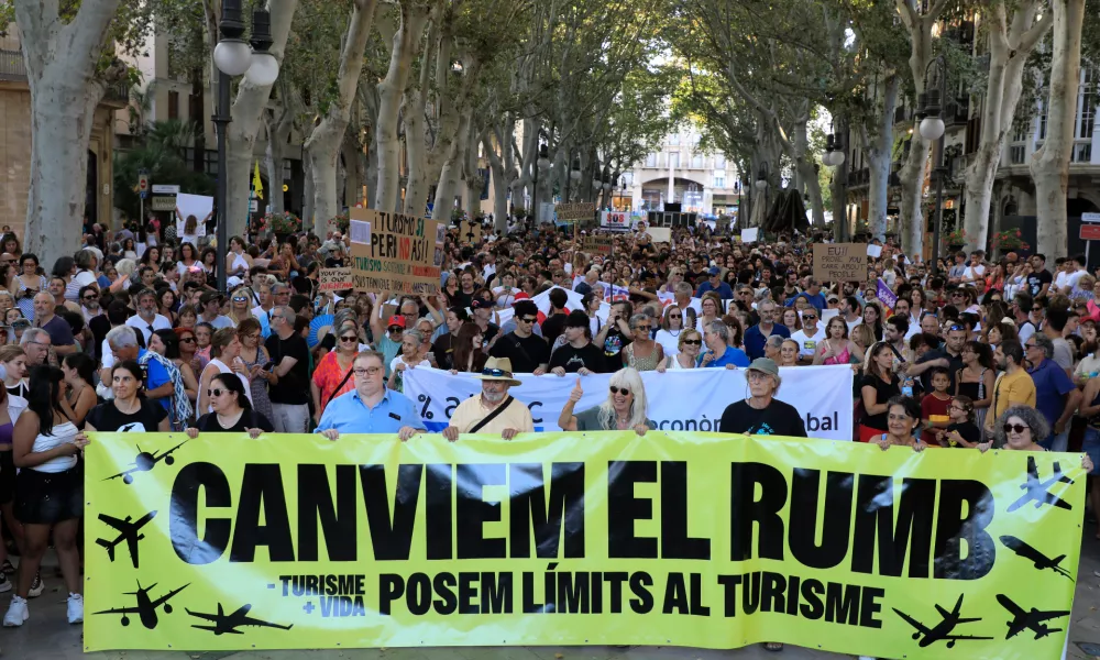 21 July 2024, Spain, Palma de Mallorca: People take part in a demonstration called by the organization "Less Tourism, More Life" against mass tourism on Mallorca. Photo: Clara Margais/dpa