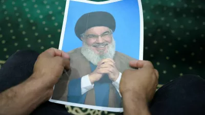 An Iraqi volunteer holds a picture of Lebanon's Hezbollah leader Sayyed Hassan Nasrallah, who has been killed, while registering his name to support Hezbollah, following a call from the Jihad and Construction Movement, a Shi'a Islamist Iraqi political party, in Basra, Iraq, on September 27, 2024. REUTERS/Essam al-Sudani