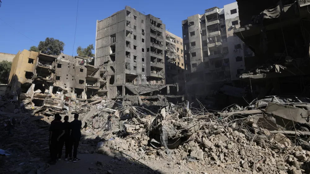 People check the site of the assassination of Hezbollah leader Hassan Nasrallah in Beirut's southern suburbs, Sunday, Sept. 29, 2024. (AP Photo/Hassan Ammar)