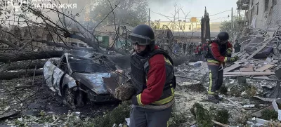 In this photo provided by the Ukrainian Emergency Service, emergency workers clear the rubble after Russia attacked the city with guided bombs overnight in Zaporizhzhia, Ukraine, Sunday, Sept. 29, 2024. (Ukrainian Emergency Service via AP)