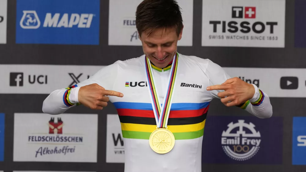 Slovenia's Tadej Pogacar wearing the World Champion's rainbow jersey reacts after winning the Men Elite road race of the Cycling and Para-cycling Road World Championships in Zurich, Switzerland, Sunday, Sept. 29, 2024. (AP Photo/Peter Dejong)