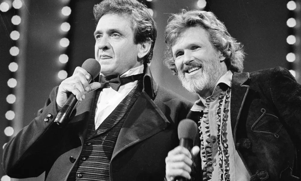 FILE - Country stars Johnny Cash, left and Kris Kristofferson sing during the Country Music Awards in Nashville, Tenn., Oct. 1983. Kristofferson, a Rhodes scholar with a deft writing style and rough charisma who became a country music superstar and A-list Hollywood actor, has died Saturday, Sept. 28, 2024. (AP Photo, File)