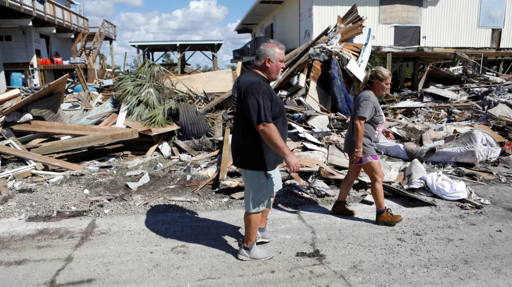 Tripp Gunti (L) and his sister Beth Harkala, residents of Keaton Beach work to recover their belongings from their family home after Hurricane Helene passed through the Florida panhandle, severely impacting the community in Keaton Beach, Florida, U.S., September 29, 2024. REUTERS/Octavio Jones