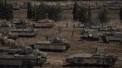 Israeli soldiers work on tanks and armoured personnel carriers (APC) in northern Israel, Monday, Sept. 30, 2024. (AP Photo/Leo Correa)