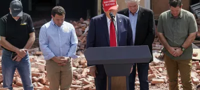 Republican presidential nominee and former U.S. President Donald Trump stands during a moment of silence at an event about the damage caused by Hurricane Helene, in Valdosta, Georgia, U.S., September 30, 2024. REUTERS/Elijah Nouvelage   TPX IMAGES OF THE DAY