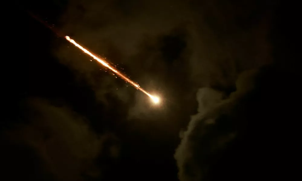 A projectile is seen in the sky after Iran fired a salvo of ballistic missiles, amid cross-border hostilities between Hezbollah and Israel, as seen from Tel Aviv, Israel, October 1, 2024. REUTERS/Ammar Awad