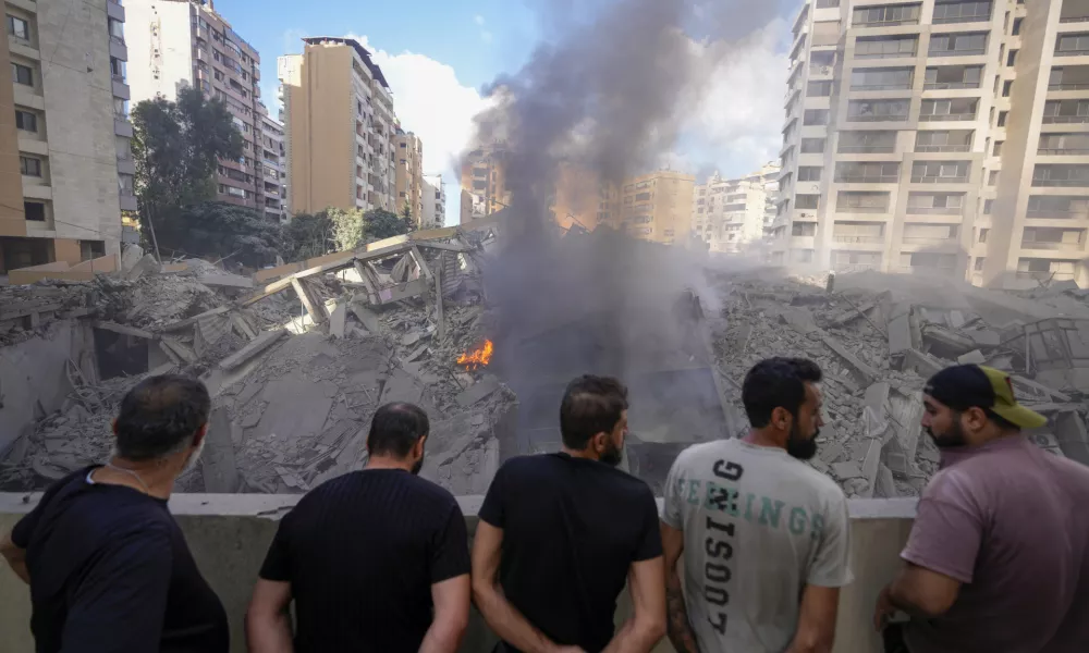 People check the site of an Israeli airstrike in Dahiyeh, Beirut, Lebanon, Wednesday, Oct. 2, 2024. (AP Photo/Hassan Ammar)