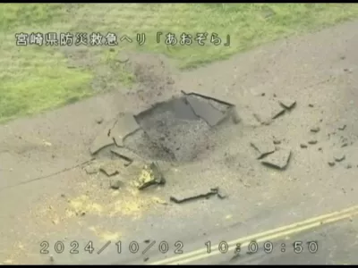 This image from video taken from a helicopter of Miyazaki Prefecture shows part of a damaged taxiway at Miyazaki Airport in southwestern Japan, Wednesday, Oct. 2, 2024, after an explosion was reported. The words at top read: Miyazaki Prefecture Disaster Prevention and Emergency Care Helicopter Aozora. (Miyazaki Prefecture via AP)