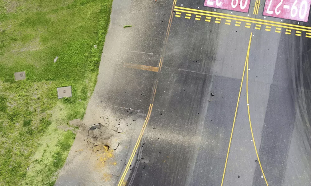 This photo taken from a Kyodo News helicopter shows part of a damaged taxiway, center, at Miyazaki Airport in southwestern Japan, Wednesday, Oct. 2, 2024, after an explosion was reported. (Kyodo News via AP)