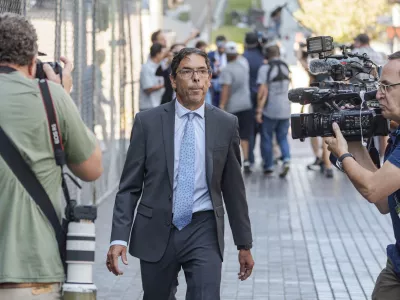 Dr. Mark Chavez, a physician from San Diego, who is charged in connection with Matthew Perry's fatal overdose, walks ahead of his with his criminal defense attorney, Matthew Binninger, seen in rear after pleading guilty to conspiring to distribute the surgical anesthetic ketamine in Los Angeles on Wednesday, Oct. 2, 2024. (AP Photo/Damian Dovarganes)