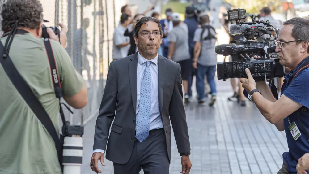 Dr. Mark Chavez, a physician from San Diego, who is charged in connection with Matthew Perry's fatal overdose, walks ahead of his with his criminal defense attorney, Matthew Binninger, seen in rear after pleading guilty to conspiring to distribute the surgical anesthetic ketamine in Los Angeles on Wednesday, Oct. 2, 2024. (AP Photo/Damian Dovarganes)