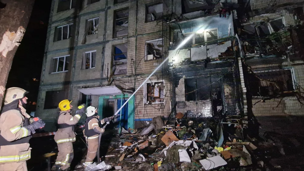 03 October 2024, Ukraine, Kharkiv: Firefighters extinguish the fire in a residential building that was damaged by a Russian missile attack. Photo: ---/Ukrinform/dpa