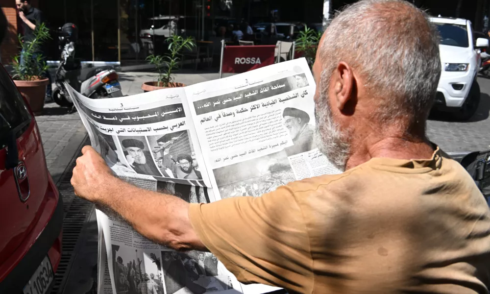 BEIRUT, LEBANON - SEPTEMBER 29: People read the news about the death of Hezbollah's Secretary-General Hassan Nasrallah, who lost his life after Israeli army's airstrike which was carried out by F-35 fighter jets, on newspapers in Beirut, Lebanon on September 29, 2024. Houssam Shbaro / AnadoluNo Use USA No use UK No use Canada No use France No use Japan No use Italy No use Australia No use Spain No use Belgium No use Korea No use South Africa No use Hong Kong No use New Zealand No use Turkey