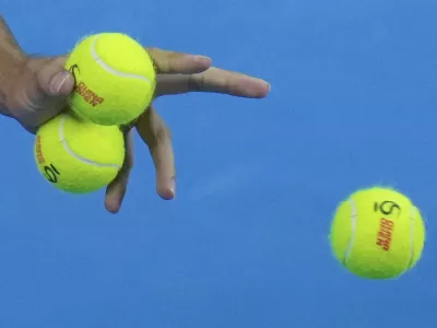 Carlos Alcaraz of Spain chooses balls during the men's singles finals match against Jannik Sinner of Italy at the China Open tennis tournament, National Tennis Center in Beijing, Wednesday, Oct. 2, 2024. (AP Photo/Andy Wong)