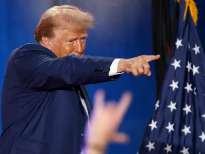 Republican presidential nominee and former U.S. President Donald Trump points to a supporter at the end of a town hall as he campaigns in Fayetteville, North Carolina, U.S. October 4, 2024. REUTERS/Jonathan Drake