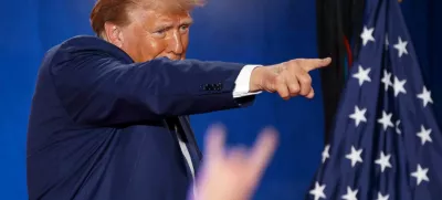 Republican presidential nominee and former U.S. President Donald Trump points to a supporter at the end of a town hall as he campaigns in Fayetteville, North Carolina, U.S. October 4, 2024. REUTERS/Jonathan Drake