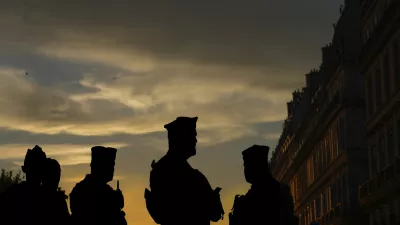 French police officers stand guard outside the Tuileries garden as the cauldron is extinguished on the final day of the 2024 Summer Olympics ahead of the closing ceremony, Sunday, Aug. 11, 2024, in Paris, France. (AP Photo/Dar Yasin)