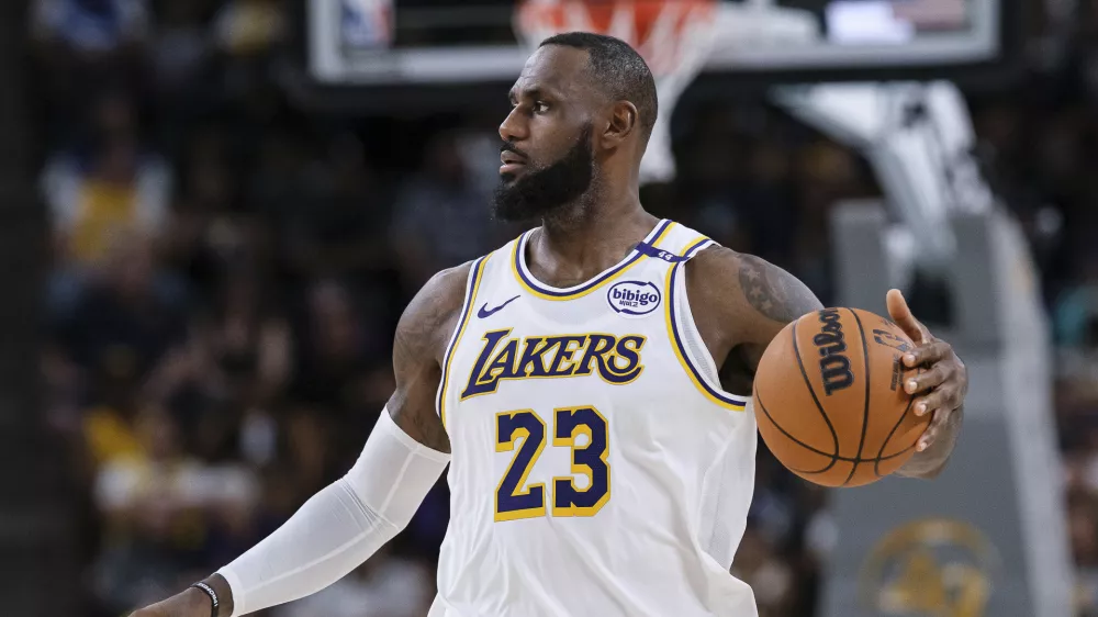 Los Angeles Lakers forward LeBron James (23) dribbles the ball during the first half of a preseason NBA basketball game against the Phoenix Suns, Sunday, Oct. 6, 2024, in Palm Desert, Calif. (AP Photo/William Liang)