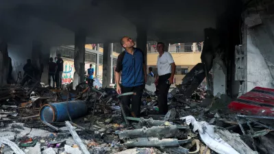 Palestinians inspect the site of an Israeli strike on a school sheltering displaced people, amid Israel-Hamas conflict, in Deir Al-Balah, in the central Gaza Strip, October 6, 2024. REUTERS/Ramadan Abed   TPX IMAGES OF THE DAY