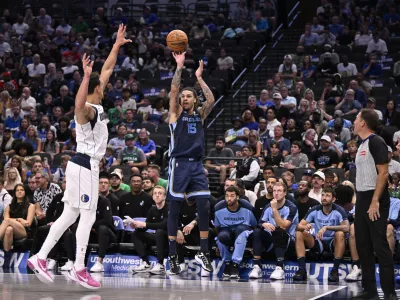 Oct 7, 2024; Dallas, Texas, USA; Memphis Grizzlies forward Brandon Clarke (15) makes a shot over Dallas Mavericks center Dwight Powell (7) during the second half at the American Airlines Center. Mandatory Credit: Jerome Miron-Imagn Images