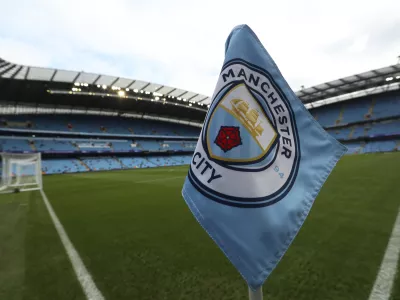 FILE - The club logo decorates a corner flag before the English Premier League soccer match between Manchester City and Newcastle United at the Etihad Stadium in Manchester, England, Saturday, Sept. 1, 2018. (AP Photo/Jon Super, File)