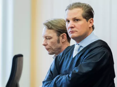 A man, who is a suspect in the disappearance of British toddler Madeleine McCann in Portugal, and his lawyer Friedrich Fuelscher wait for the verdict in a trial on unrelated sexual assault charges in Braunschweig, Germany, October 8, 2024. Christian B., is charged with three counts of aggravated rape and two counts of sexual abuse of children in Portugal between June 2007 and December 2000.   Michael Matthey/Pool via REUTERS