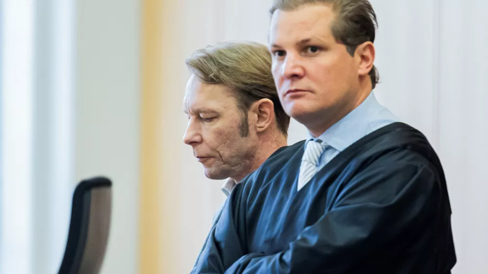 A man, who is a suspect in the disappearance of British toddler Madeleine McCann in Portugal, and his lawyer Friedrich Fuelscher wait for the verdict in a trial on unrelated sexual assault charges in Braunschweig, Germany, October 8, 2024. Christian B., is charged with three counts of aggravated rape and two counts of sexual abuse of children in Portugal between June 2007 and December 2000.   Michael Matthey/Pool via REUTERS