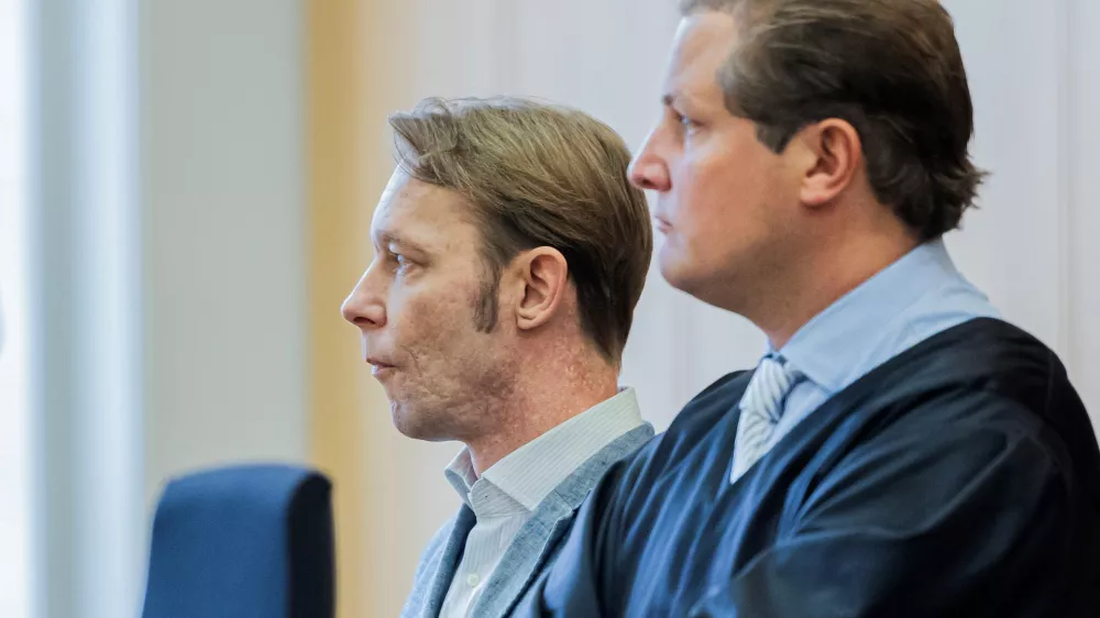 A man, who is a suspect in the disappearance of British toddler Madeleine McCann in Portugal, and his lawyer Friedrich Fuelscher wait for the verdict in a trial on unrelated sexual assault charges in Braunschweig, Germany, October 8, 2024. Christian B., is charged with three counts of aggravated rape and two counts of sexual abuse of children in Portugal between June 2007 and December 2000.   Michael Matthey/Pool via REUTERS