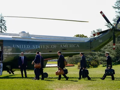 Staff boards Marine One before U.S. President Joe Biden departs for Wisconsin from the South Lawn of the White House in Washington, U.S., October 8, 2024. REUTERS/Elizabeth Frantz