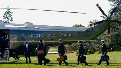 Staff boards Marine One before U.S. President Joe Biden departs for Wisconsin from the South Lawn of the White House in Washington, U.S., October 8, 2024. REUTERS/Elizabeth Frantz