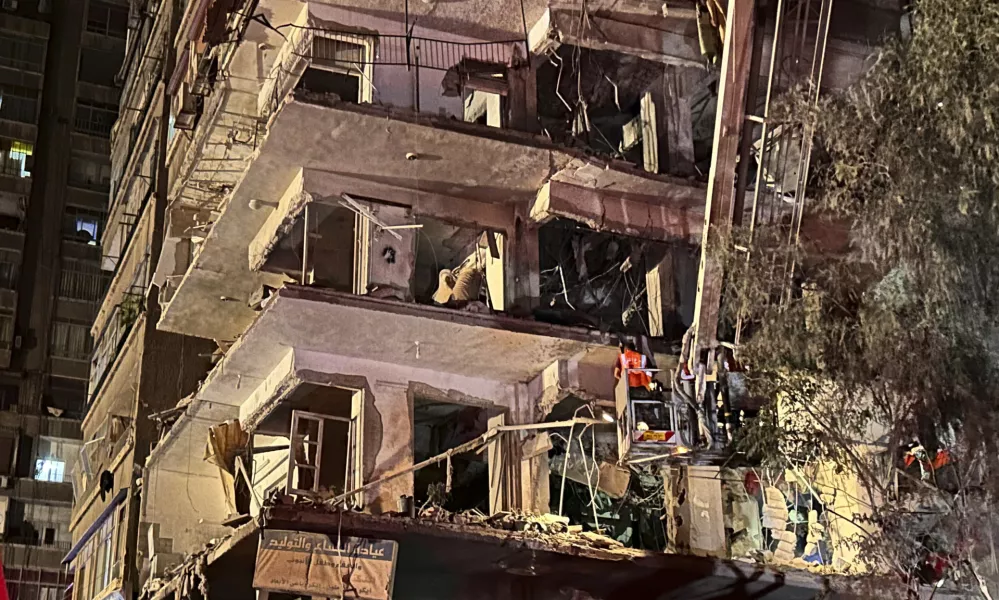 A rescue worker checks a damaged building hit by an Israeli strike in a residential building in Damascus, Syria, Tuesday, Oct. 8, 2024. (AP Photo/Omar Sanadiki)