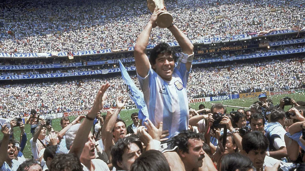 ﻿FILE - In this June 29, 1986, file photo, Diego Maradona holds up his team's trophy after Argentina's 3-2 victory over West Germany at the World Cup final soccer match at Azteca Stadium in Mexico City. The Argentine soccer great who was among the best players ever and who led his country to the 1986 World Cup title died from a heart attack on Wednesday, Nov. 25, 2020, at his home in Buenos Aires. He was 60. (AP Photo/Carlo Fumagalli, File)