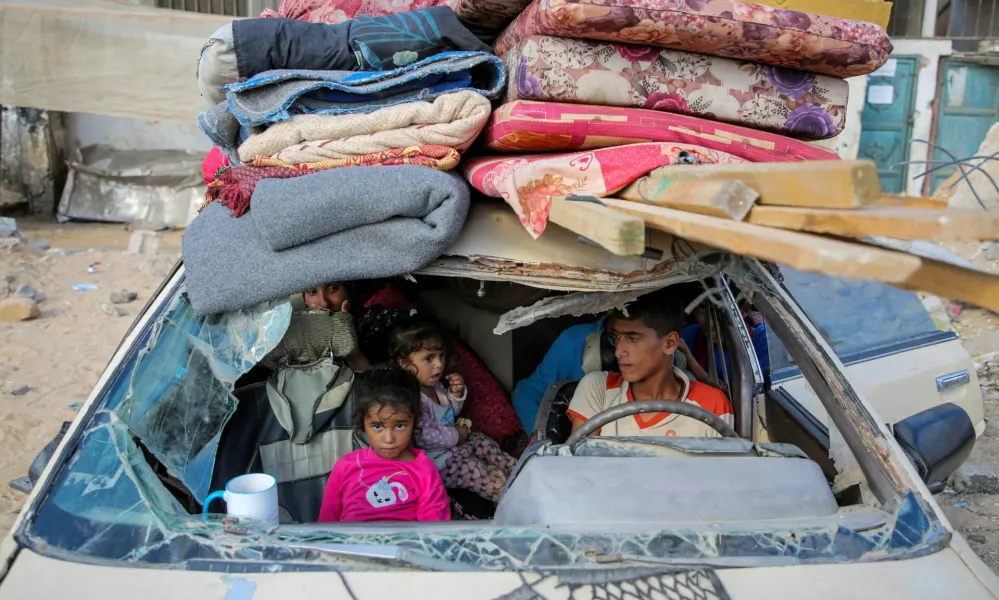 Displaced Palestinians sit in a damaged car as they flee areas in the eastern part of Khan Younis following an Israeli evacuation order, amid the ongoing conflict between Israel and Hamas, in Khan Younis in the southern Gaza Strip October 7, 2024. REUTERS/Hatem Khaled   TPX IMAGES OF THE DAY