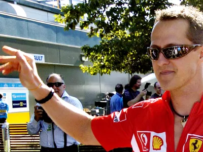 Formula One Ferrari driver Michael Schumacher of Germany waves as he arrives at the track in Melbourne, Australia, Thursday, March 30, 2006. Melbourne will host the seasons 3rd Grand Prix Sunday, April 2. (AP Photo/Steve Holland)