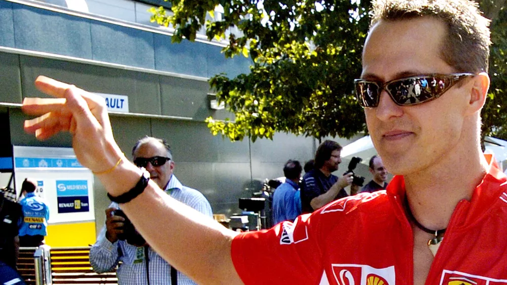 Formula One Ferrari driver Michael Schumacher of Germany waves as he arrives at the track in Melbourne, Australia, Thursday, March 30, 2006. Melbourne will host the seasons 3rd Grand Prix Sunday, April 2. (AP Photo/Steve Holland)