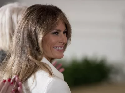 ﻿FILE - This is a Wednesday, March 29, 2017, file photo of U.S. first lady Melania Trump smiles as she is recognized by President Donald Trump as he speaks at a women's empowerment panel, in the East Room of the White House in Washington. Melania Trump on Wednesday April 12, 2017, accepted an apology and damages from the publisher of the Daily Mail newspaper for reporting rumors about her time as a model. (AP Photo/Andrew Harnik, File)