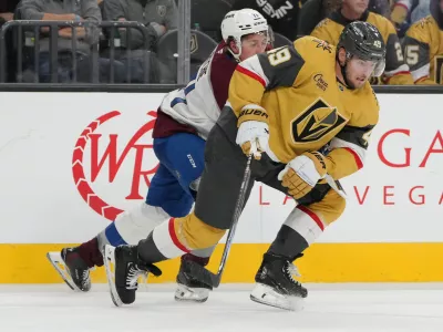 Oct 9, 2024; Las Vegas, Nevada, USA; Vegas Golden Knights center Ivan Barbashev (49) skates against Colorado Avalanche center Calum Ritchie (71) during the third period at T-Mobile Arena. Mandatory Credit: Lucas Peltier-Imagn Images